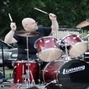 STICK WITH JESUS : Shaved-headed, earring-wearing drummer/minister